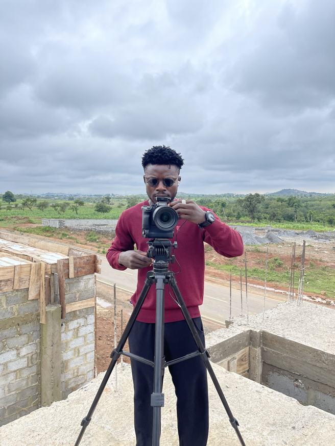 Filming on a camera tripod on a building site